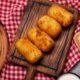 top view food croquettes wooden board 80x80