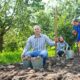 family harvesting potatoes garden 80x80