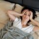 sick woman laying bed medium shot 80x80