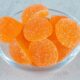 sweet orange jelly candies with sugar glass plate white surface 80x80